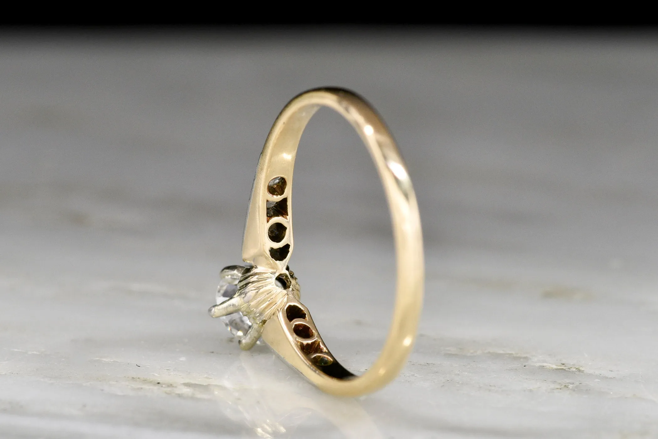 c. 1900s Gold and Platinum Ring with an Old European Cut Diamond Center and Antique Rose Cut Accents