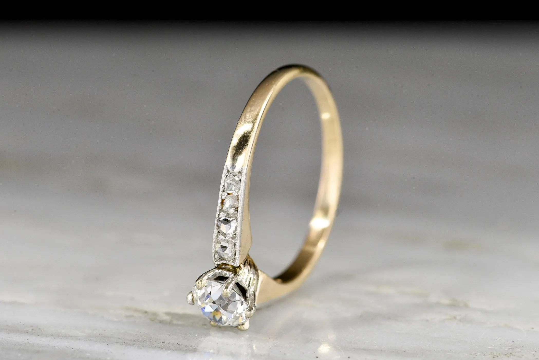 c. 1900s Gold and Platinum Ring with an Old European Cut Diamond Center and Antique Rose Cut Accents