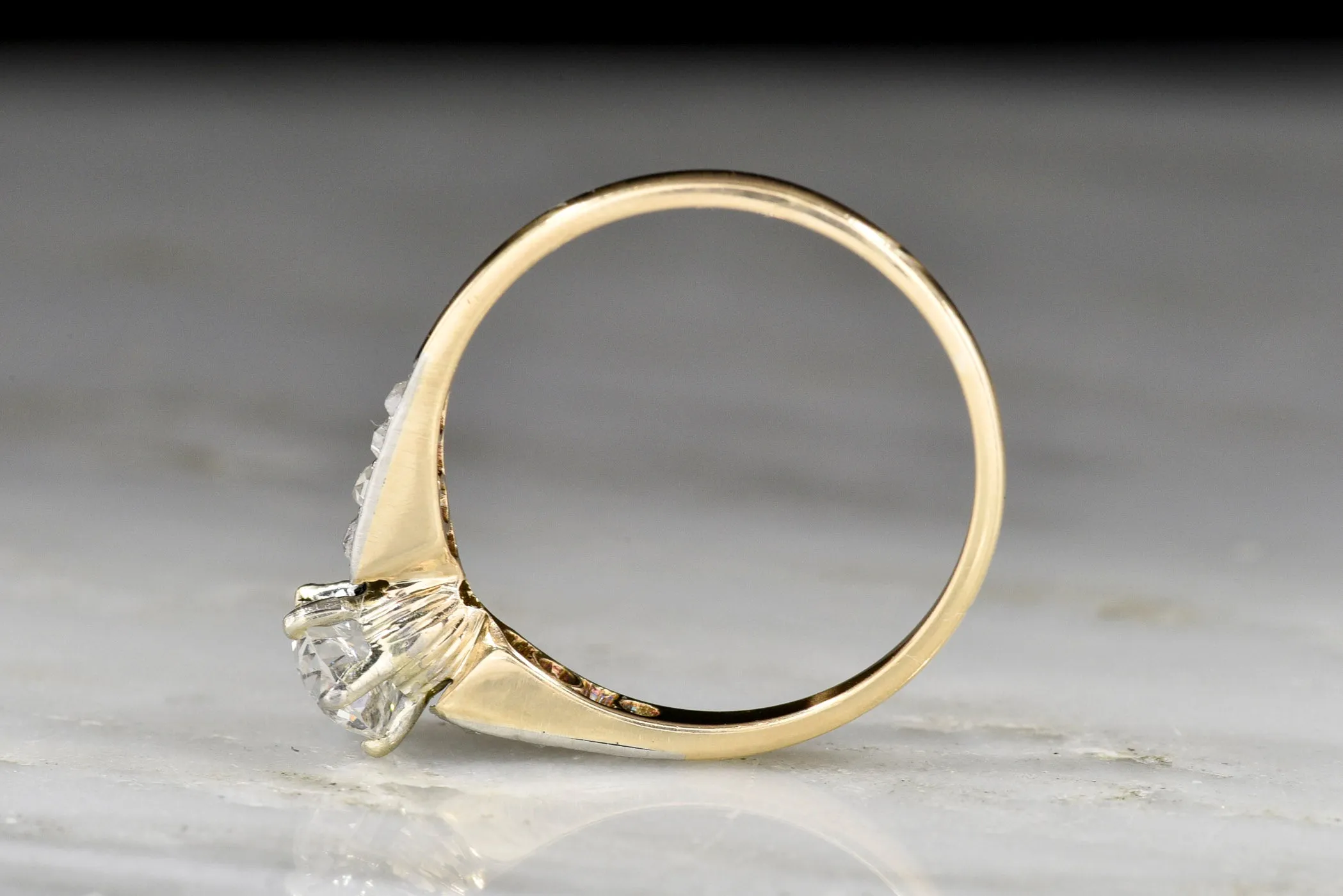 c. 1900s Gold and Platinum Ring with an Old European Cut Diamond Center and Antique Rose Cut Accents