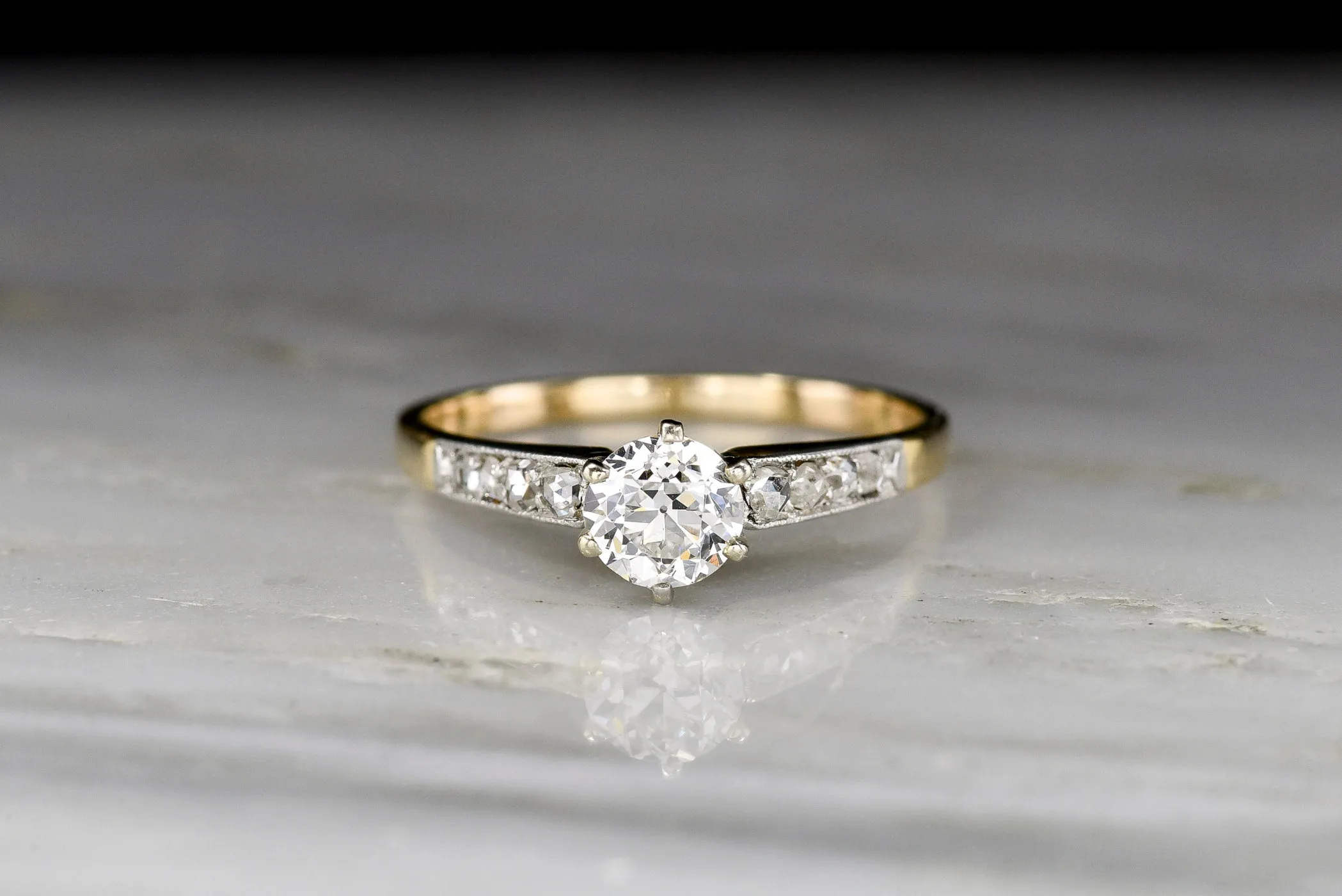 c. 1900s Gold and Platinum Ring with an Old European Cut Diamond Center and Antique Rose Cut Accents